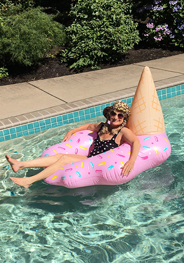 Queen Scarlett floating in a swimming pool on a cone